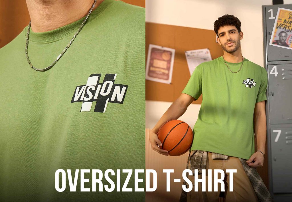 Man wearing a green oversized t-shirt for men with 'VISION' print.